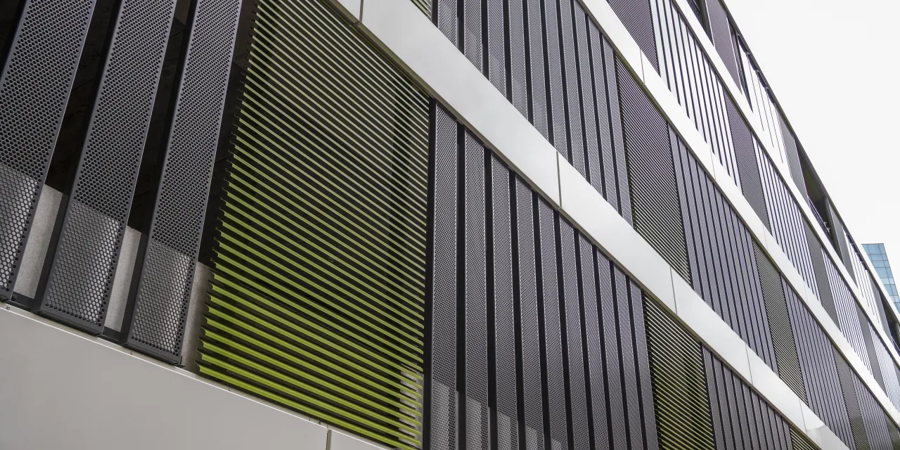 Parking garage slatted façade: Renson Linius L.050 slat & perforated metal panels